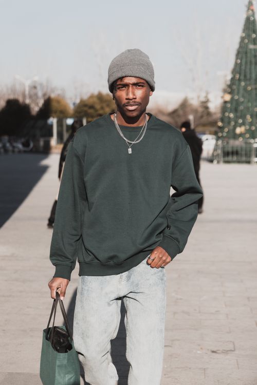 Free Fashion-forward male model showcasing urban style on a sunny day in Shanghai. Stock Photo
