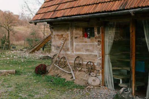 Explore the rustic charm of a Romanian countryside cottage adorned with vintage wheels and earthy tones.