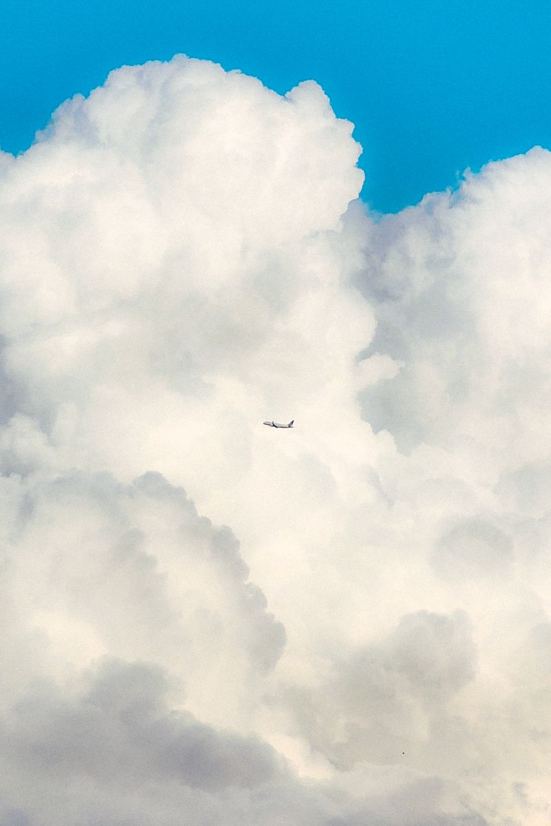 White Cloud over Flying Airplane · Free Stock Photo