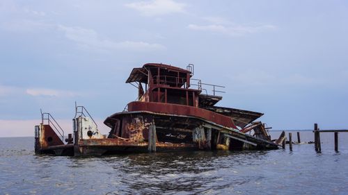 Free Rusted shipwreck against a blue sky, reflecting the passage of time. Stock Photo