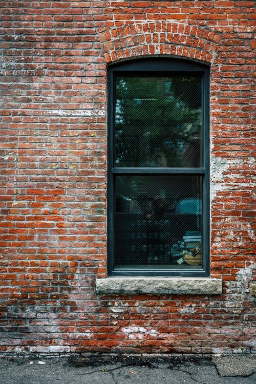 Free A weathered brick wall with a single window in Boise, Idaho. Stock Photo