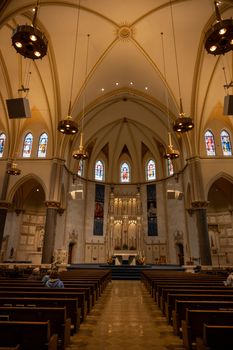 A stunning view of a Milwaukee cathedral's interior showcasing elegant architecture and stained glass windows.