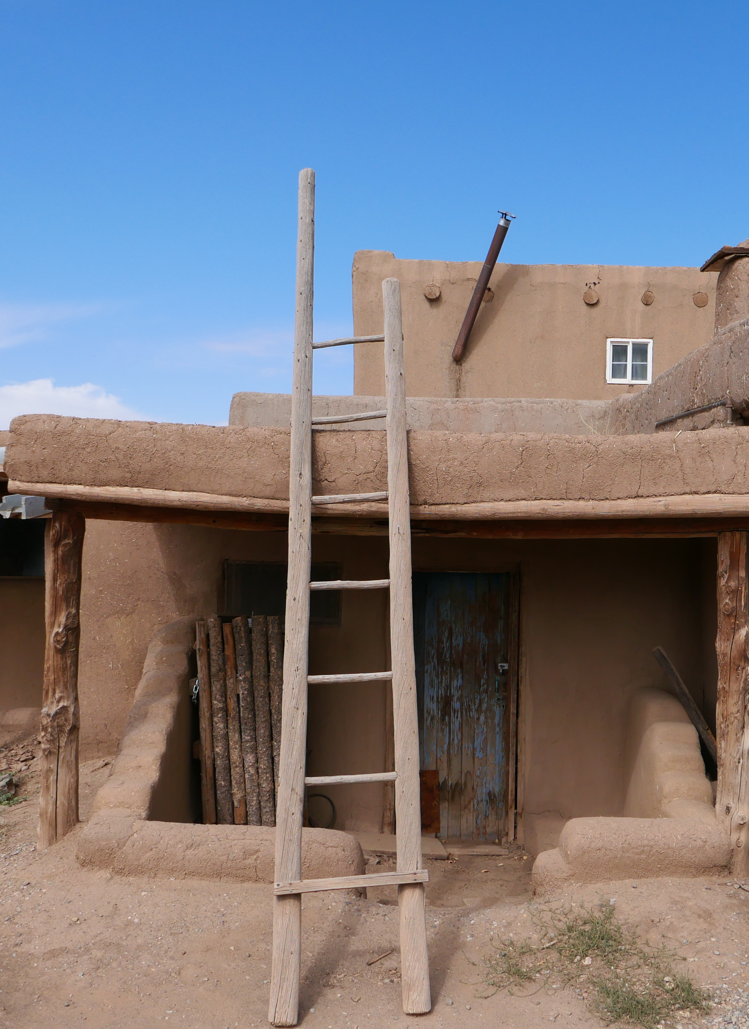 Traditional Adobe Building with Wooden Ladder in Taos · Free Stock