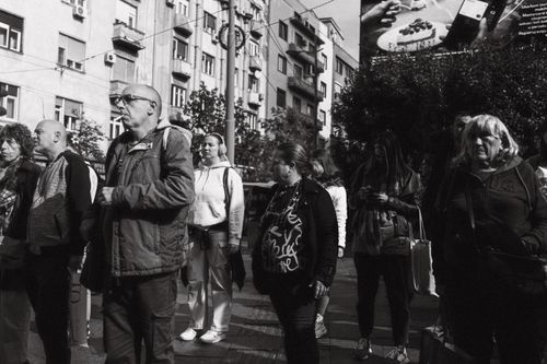 Free Monochrome urban street scene capturing a diverse group of people in a city environment. Stock Photo