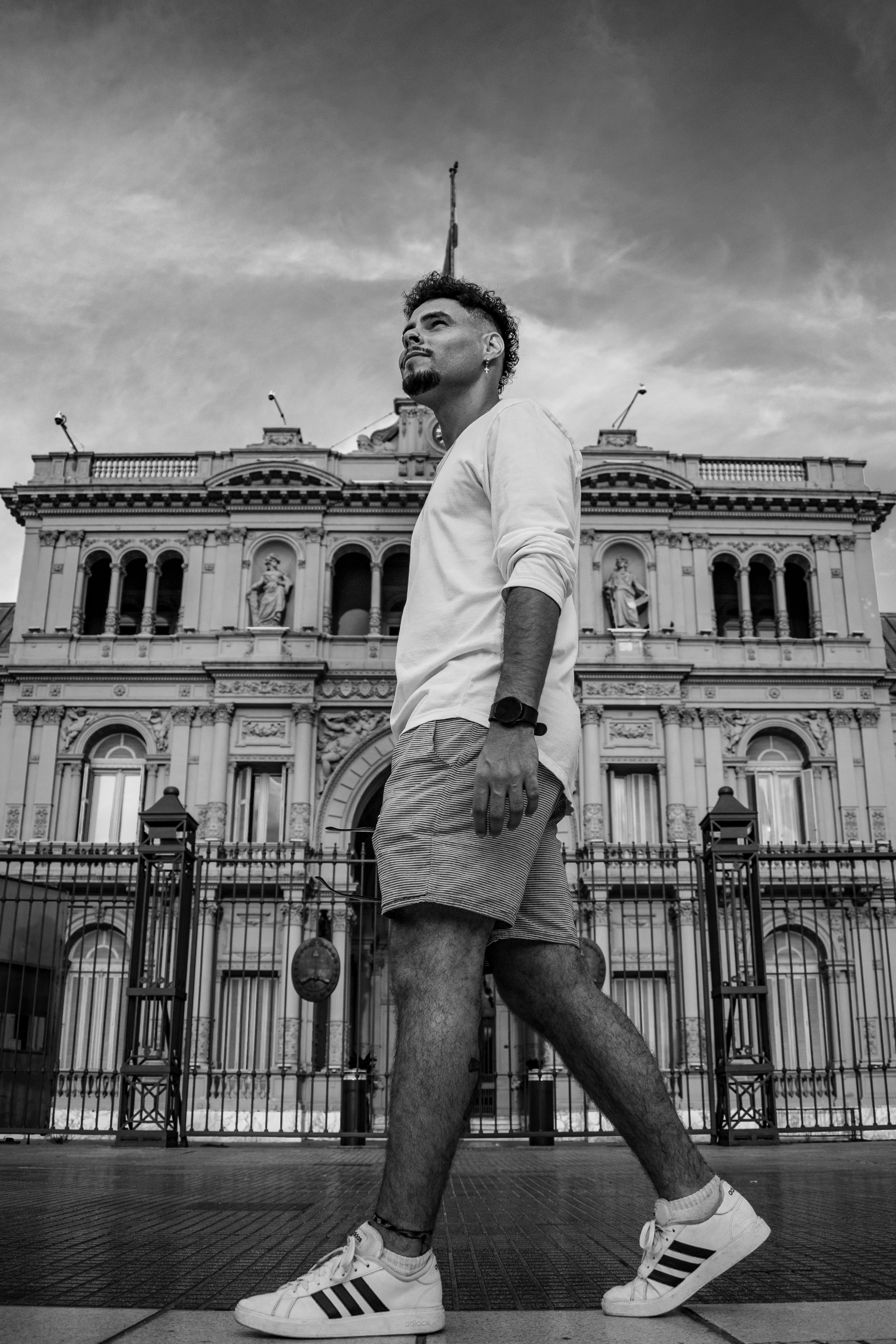 Monochrome street portrait of a man by Casa Rosada in Buenos Aires.