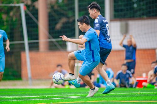 Free Two players in action during an exciting soccer match in Hanoi, Vietnam. Stock Photo