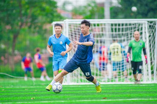 Free Dynamic soccer game with players in action on a green field, Hanoi, Vietnam. Stock Photo