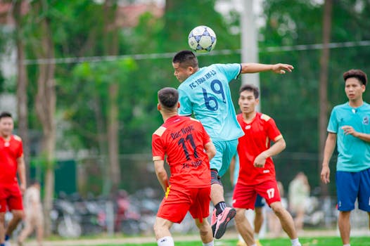 Players in action during a soccer match in Hà Nội, capturing dynamic movement.