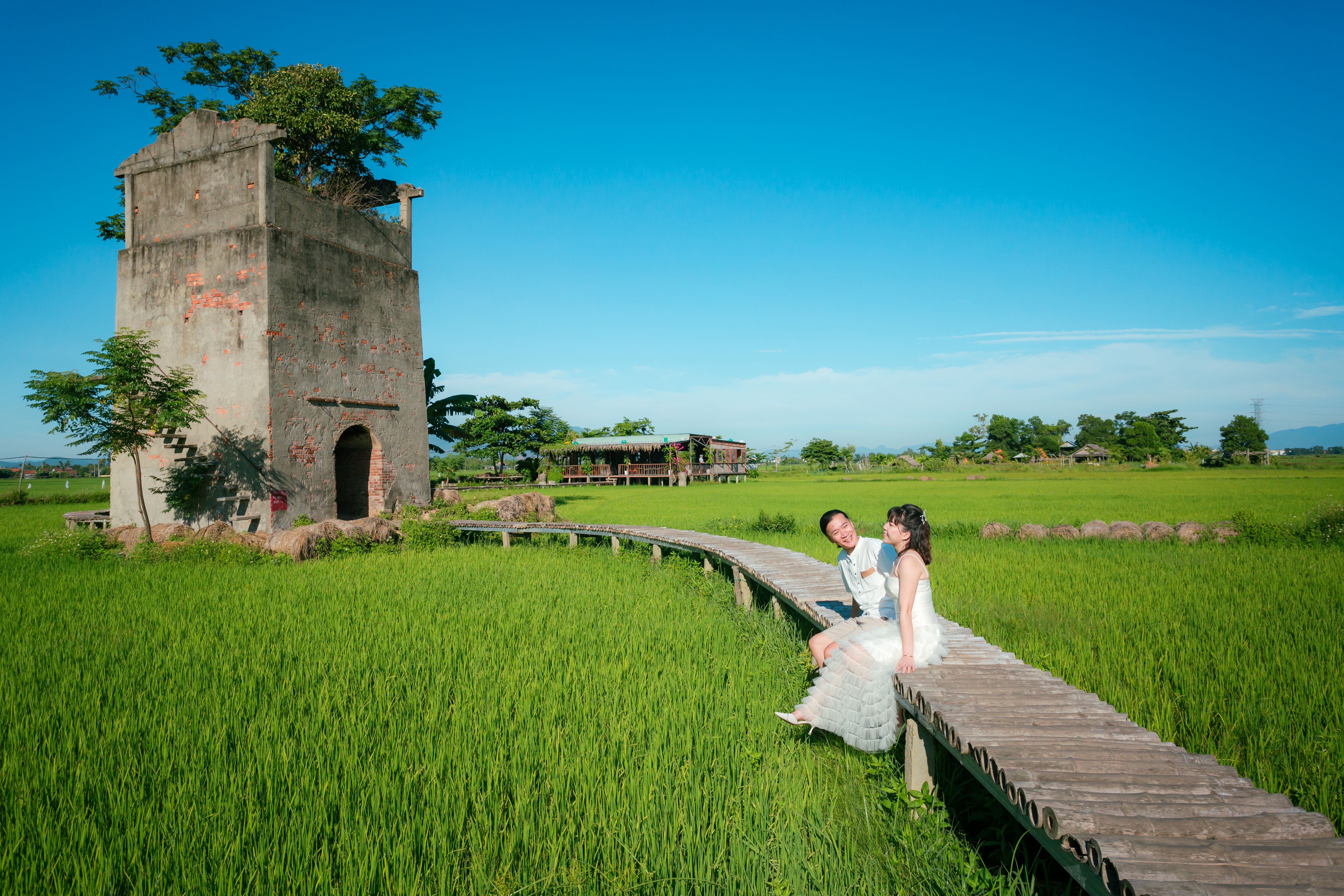 Romantic Couple Posing in Lush Green Field · Free Stock Photo