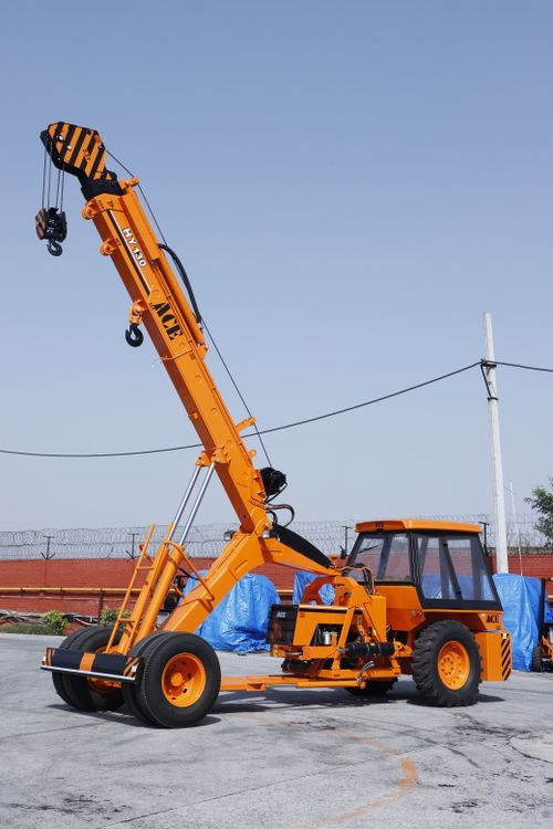 Free ACE HY130 crane parked outdoors in an industrial setting in Faridabad, India. Stock Photo