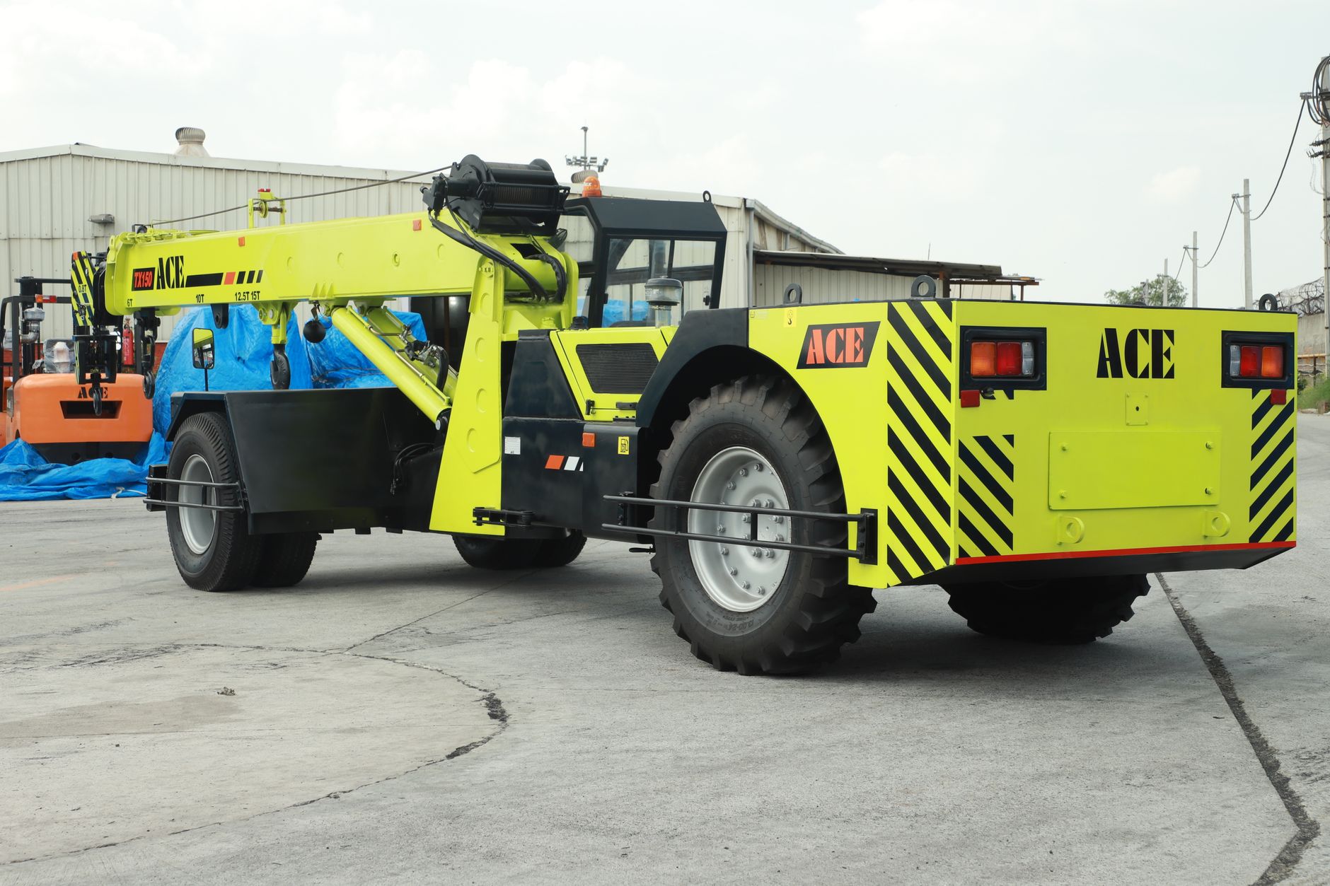 ACE TX 150 crane positioned at an outdoor construction site in Faridabad, Haryana, India.