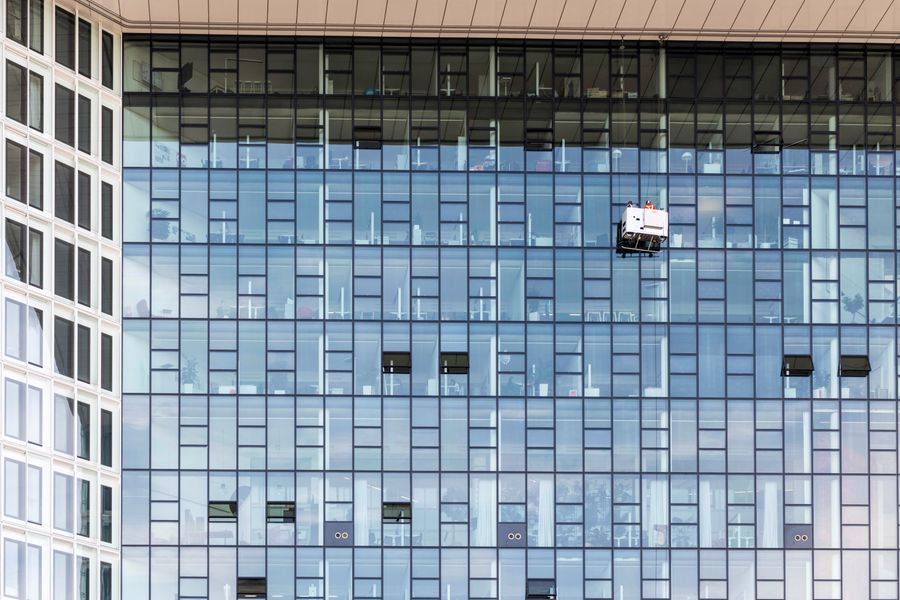 Modern office building with professional window cleaners