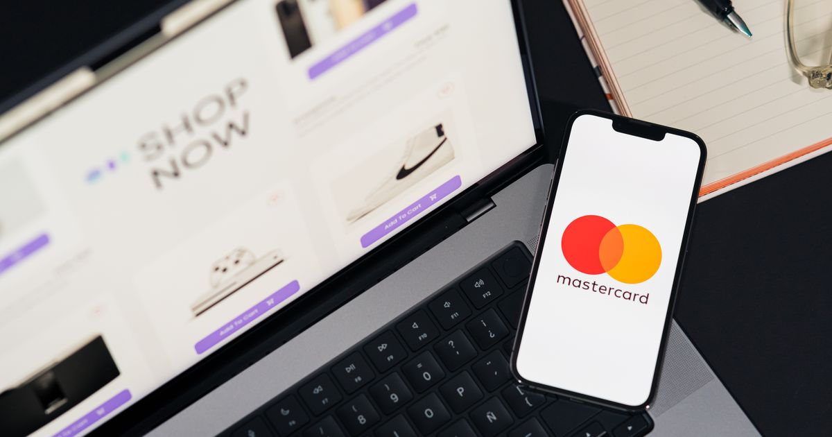 A laptop and smartphone showing a mobile payment app.