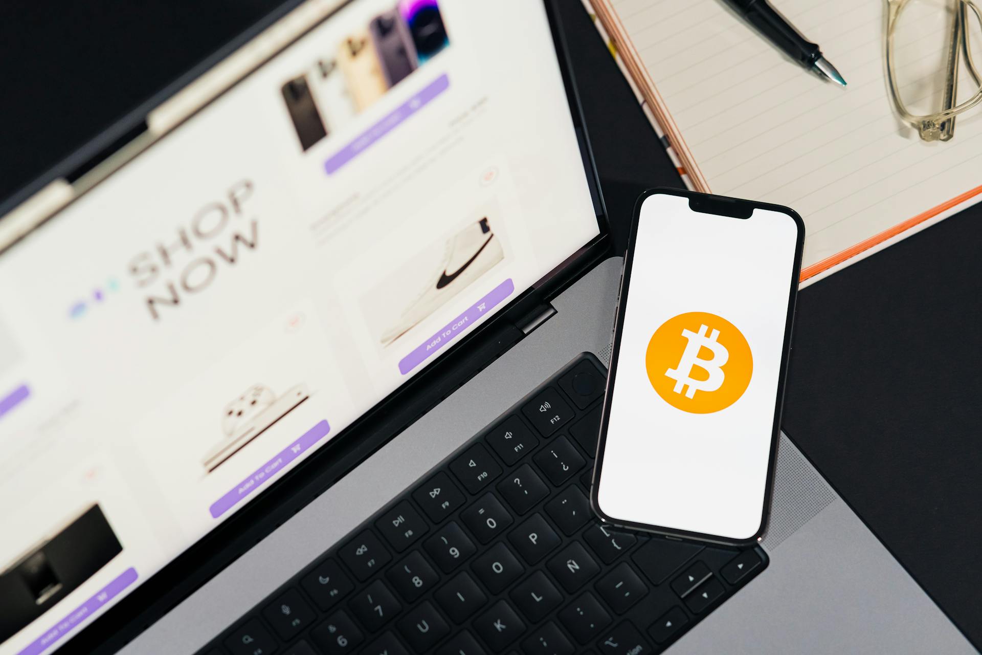 Laptop and smartphone with Bitcoin symbol, depicting digital shopping