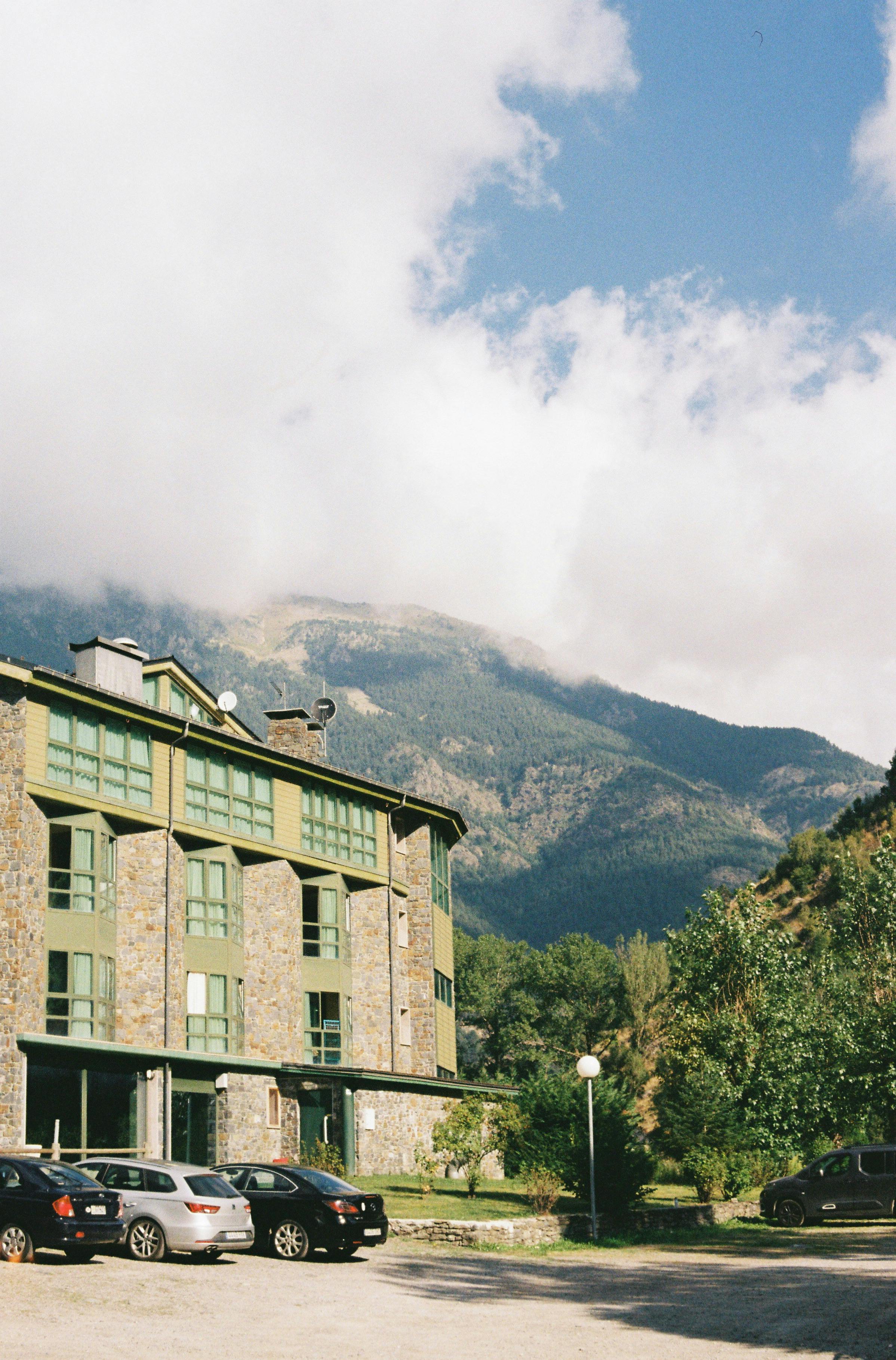 Picturesque mountain lodge with stunning backdrop and clear blue skies.