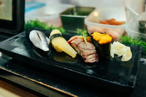 Free Close-up of assorted sushi on black platter in a Tokyo restaurant. Stock Photo