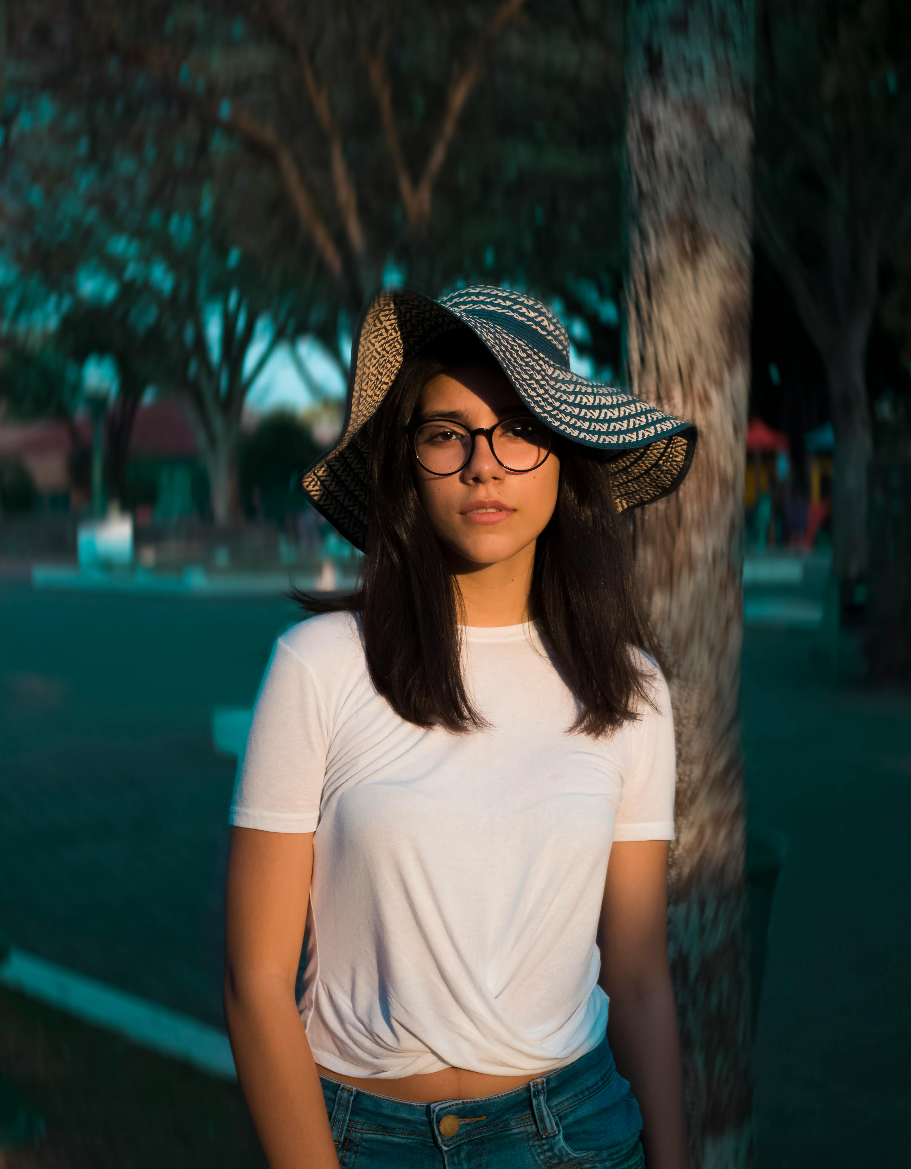 selective focus photo of woman standing near tree