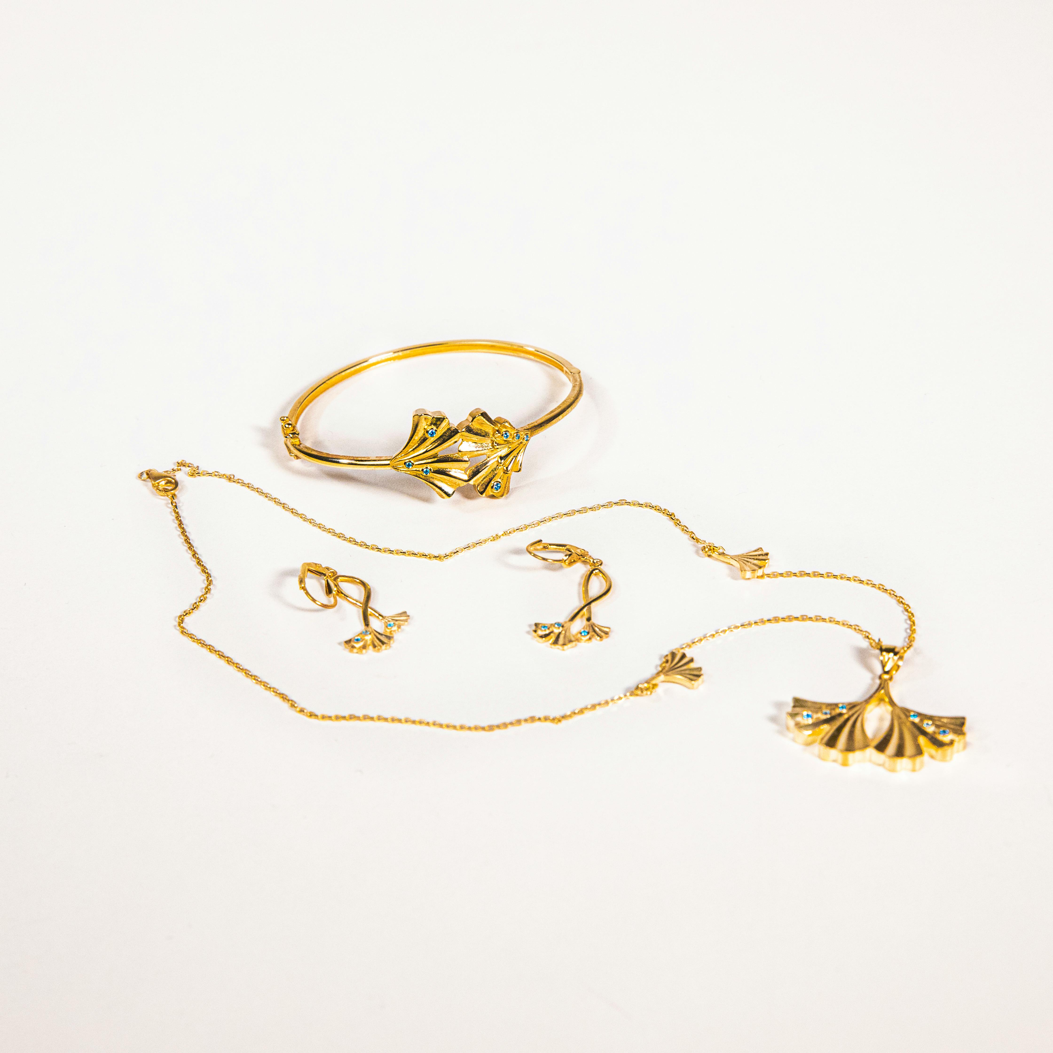 elegant gold jewelry set with ginkgo leaf design