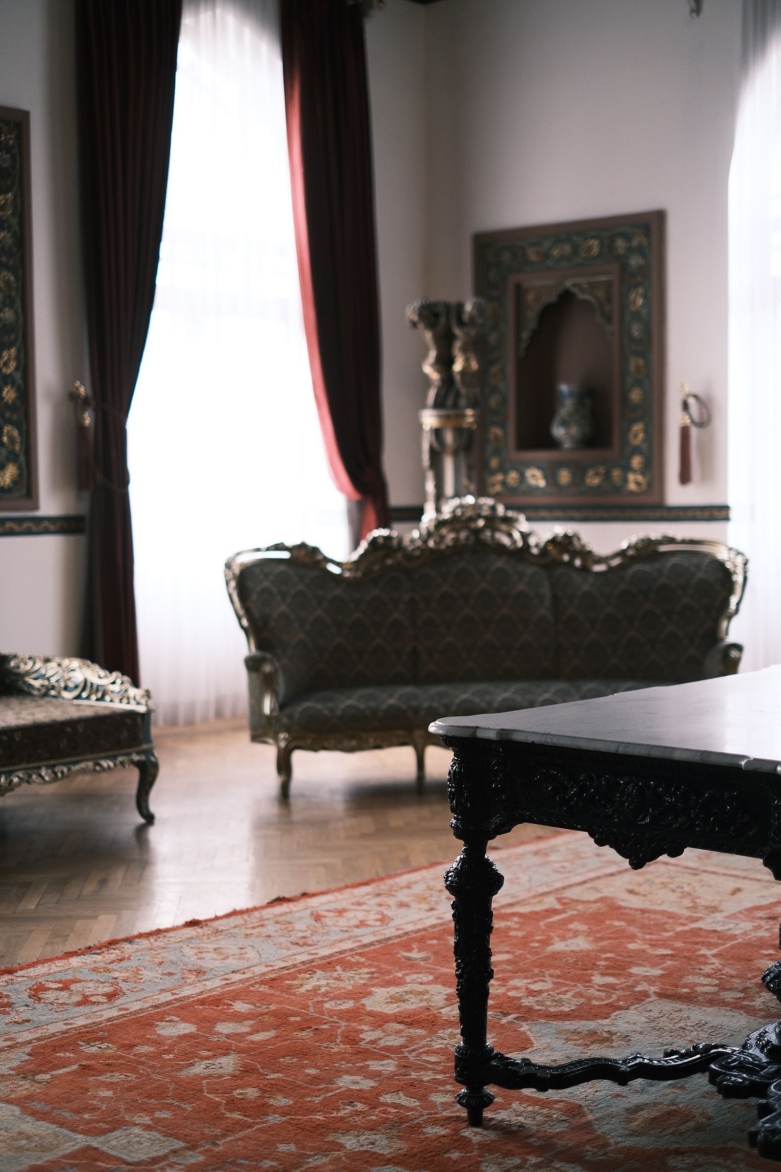 Dark carved Victorian royal center table in an elegant interior