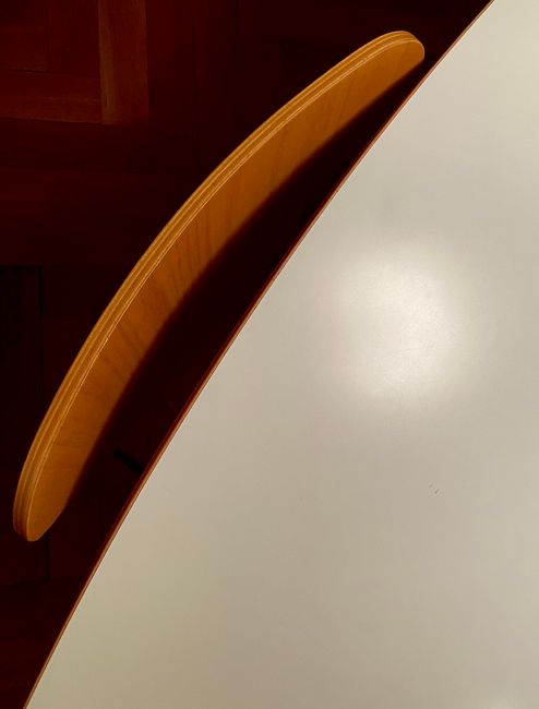 Minimalist abstract image of a chair and table with strong shadow contrast.