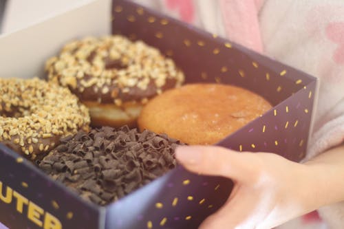 Free Person Holding Box of Donuts Stock Photo