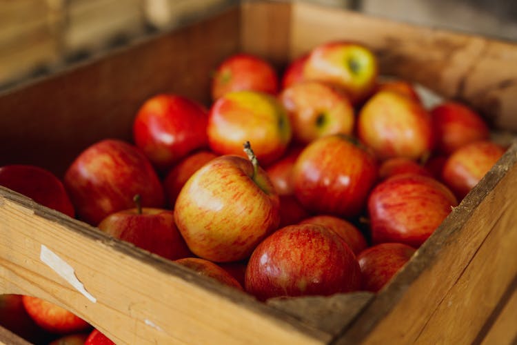 Pile Of Red Apples In Box In Store Warehouse