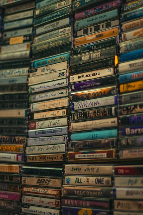 Free A nostalgic collection of various music cassette tapes stacked vertically. Stock Photo