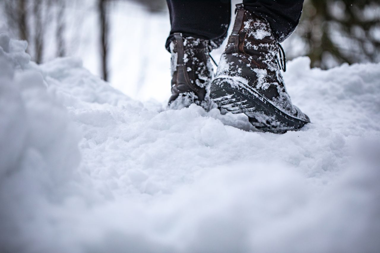 walking through deep snow in black winter boots