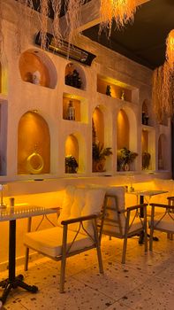 Warmly lit restaurant with elegant seating and rustic decor, creating a cozy atmosphere.
