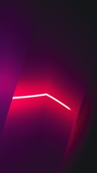 Vibrant abstract art featuring dynamic neon light lines in a dark background, showcasing modern design.