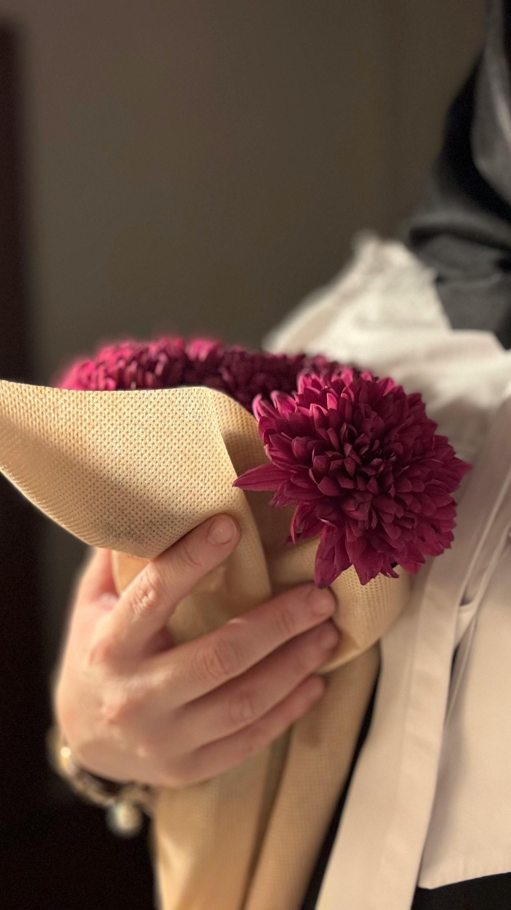 [ColoSach]-close-up-of-a-bouquet-of-purple-chrysanthemums-held-by-a-person,-symbolizing-elegance-and-care.