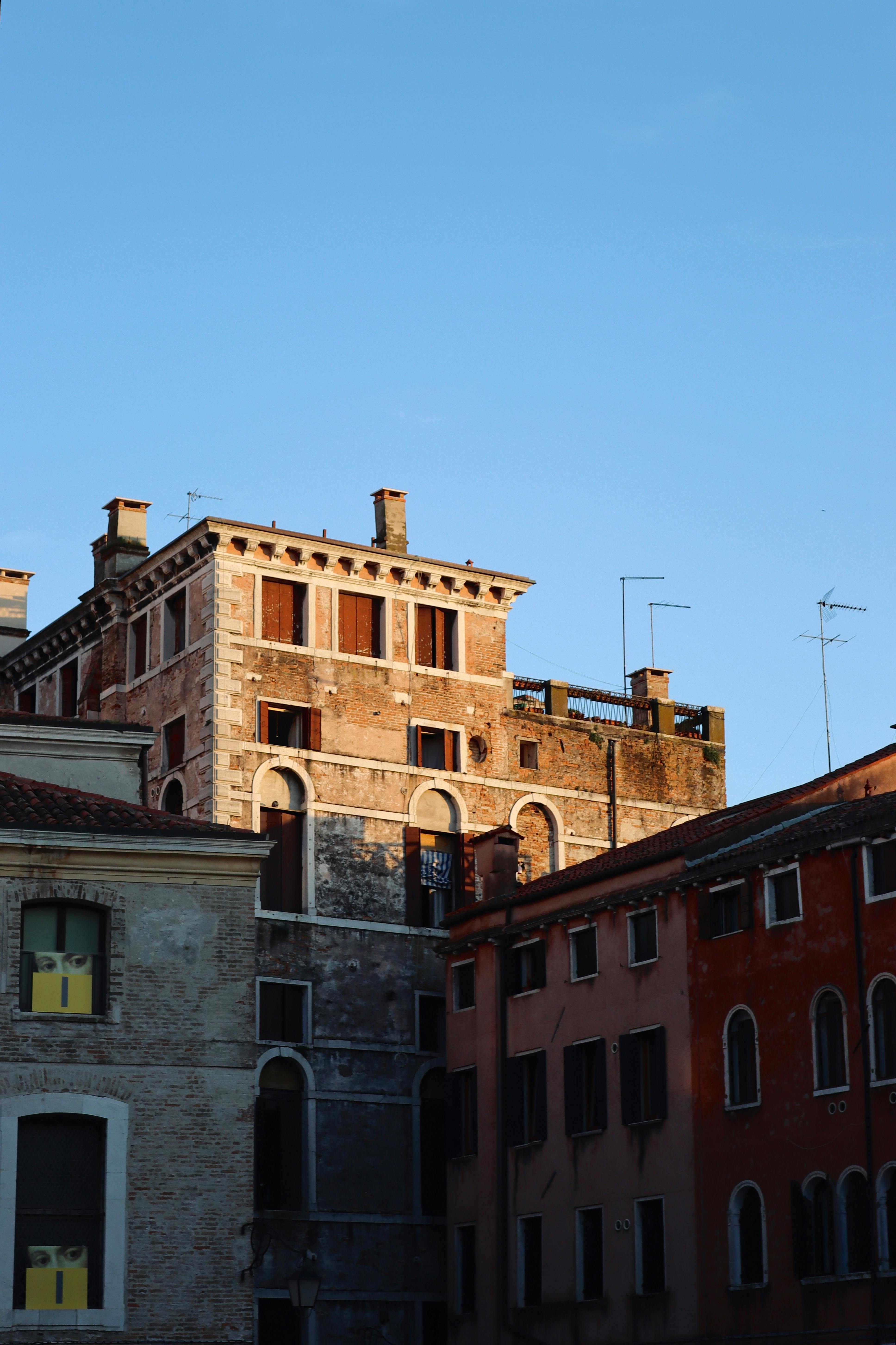 A charming view of historic buildings in Venice, Italy, bathed in sunset light.