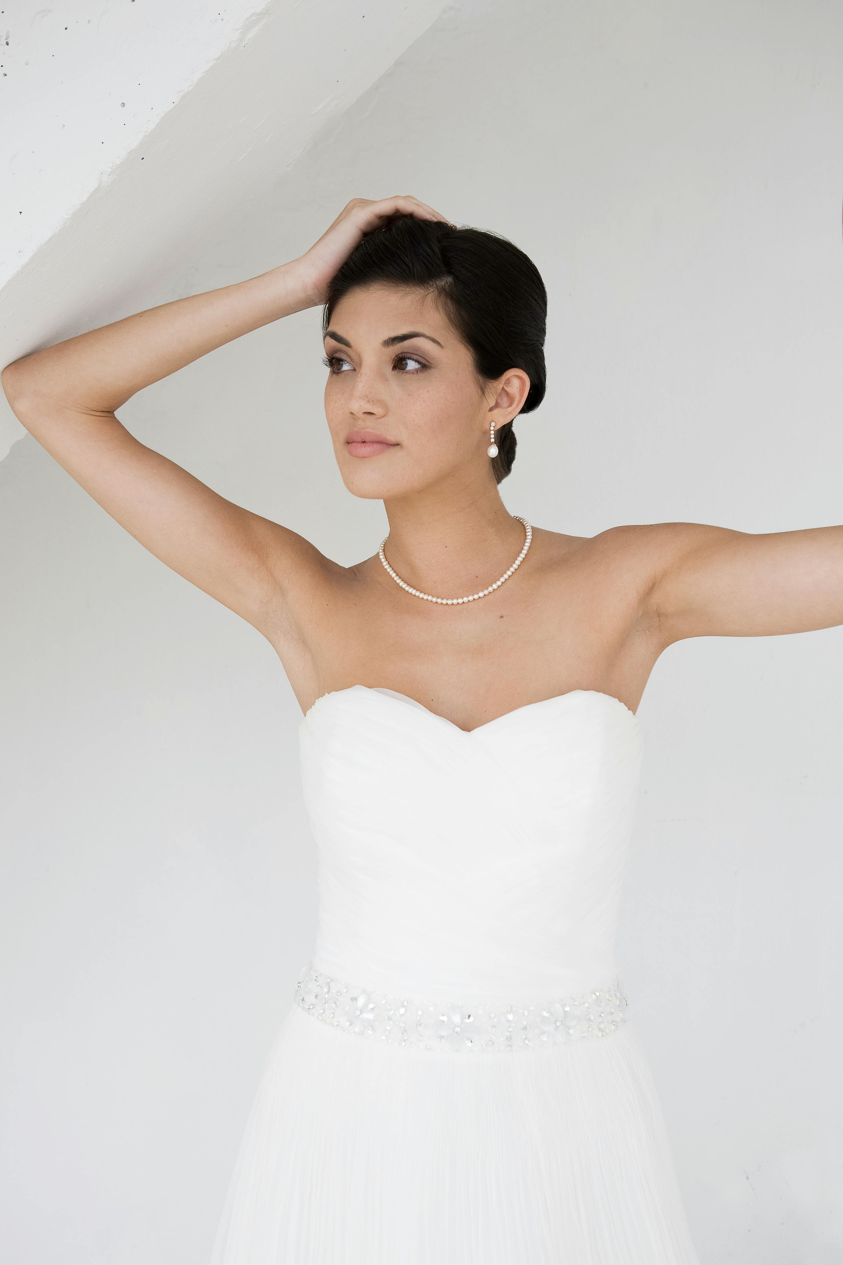 Beyaz straplez prenses gelinlik modeli, dantel detaylı korset bel ve hacimli tül etek ile bahçe düğünü için romantik tasarım, doğal ışıkta çekilmiş profesyonel fotoğraf