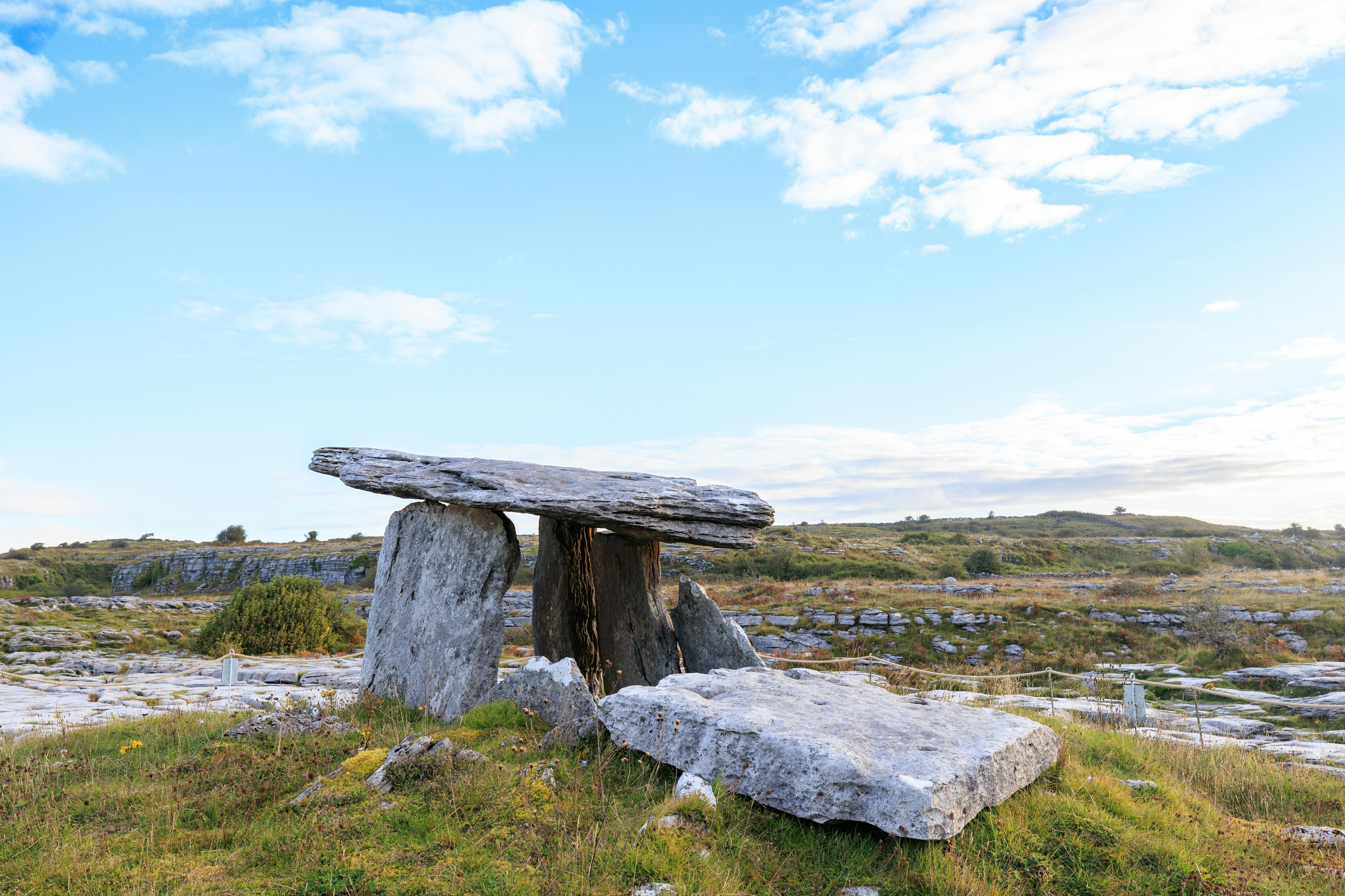 Ancient Poulnabrone dolmen amidst rugged landscapes in Clare, Ireland.
