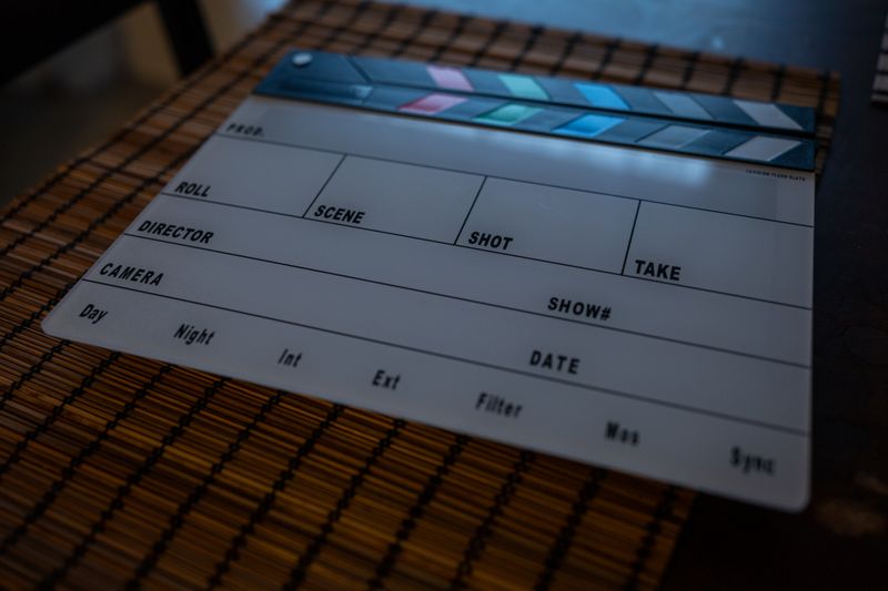 Close-up of a film clapperboard on a bamboo mat, ideal for filmmaking concepts.