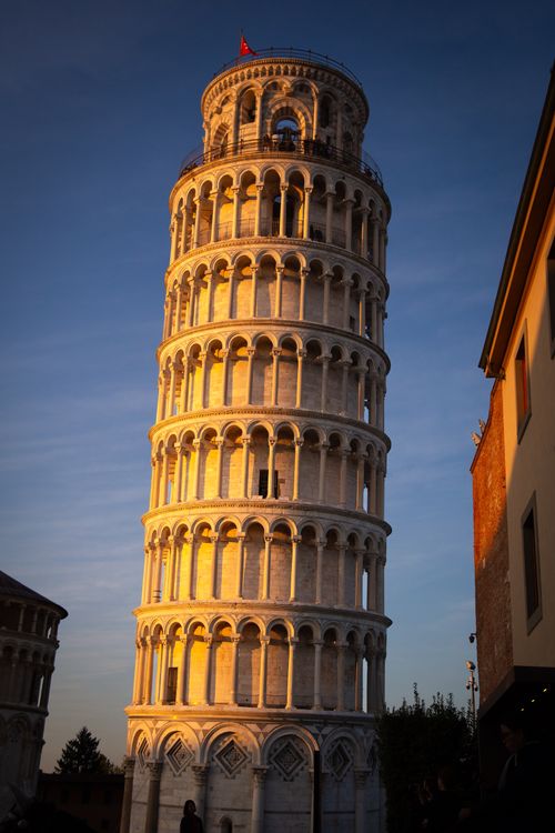 Free A stunning view of the Leaning Tower of Pisa captured during sunset under a clear sky. Stock Photo