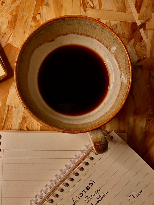 Free Cozy setup with coffee and notebook on a wooden desk, perfect for studying. Stock Photo