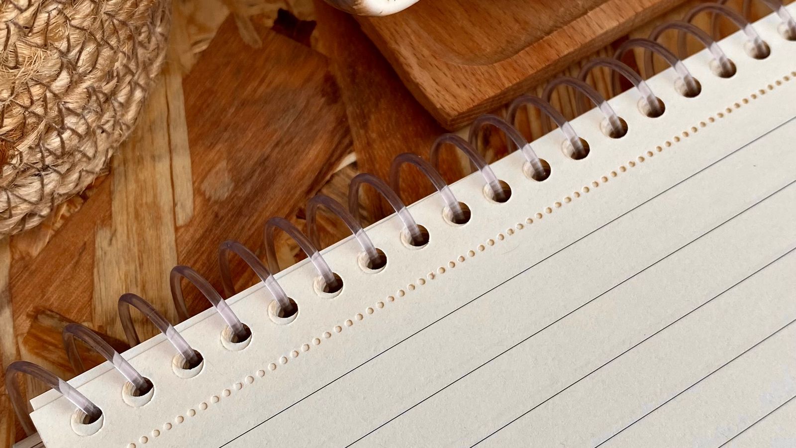 An open lined notebook on a wooden table