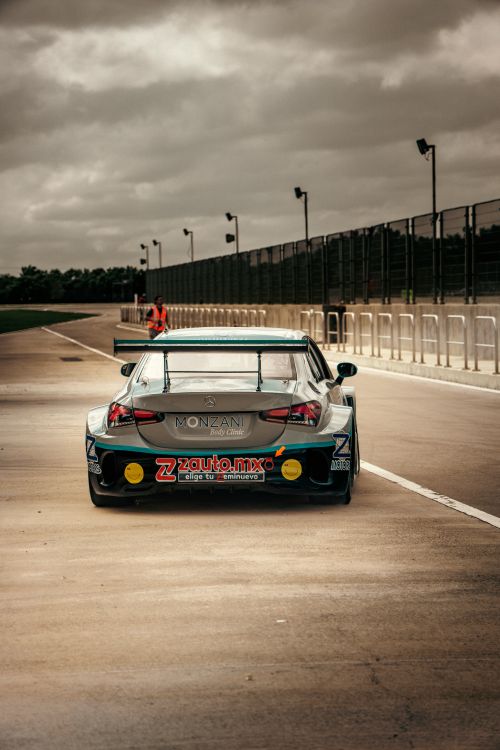 Rear View of Race Car on Track in Cloudy Weather · Free Stock Photo