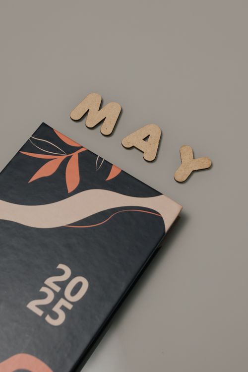 Free A stylish 2025 calendar with 'May' displayed using wooden letters on a minimalist backdrop. Stock Photo