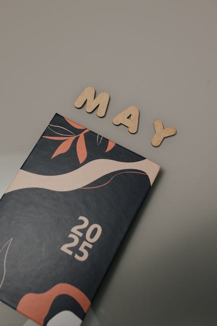 Elegant 2025 planner design with MAY letters on a minimalistic background.