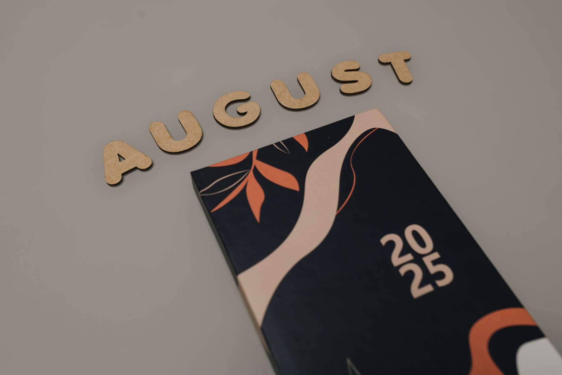 Fan organizing a printed 2026 World Cup calendar beside a laptop showing official FIFA fixtures