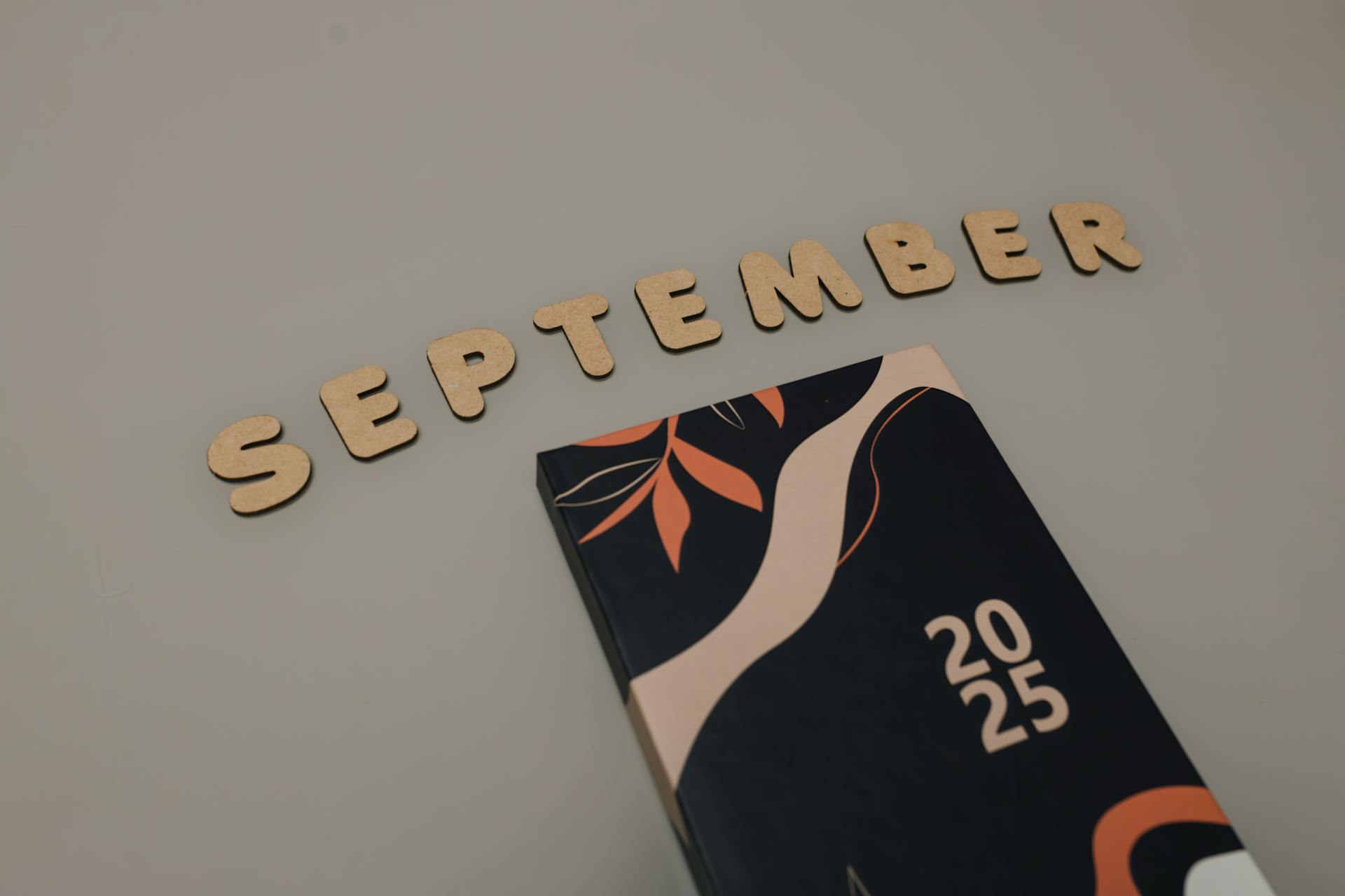 Stylized September typography with abstract 2025 calendar cover.