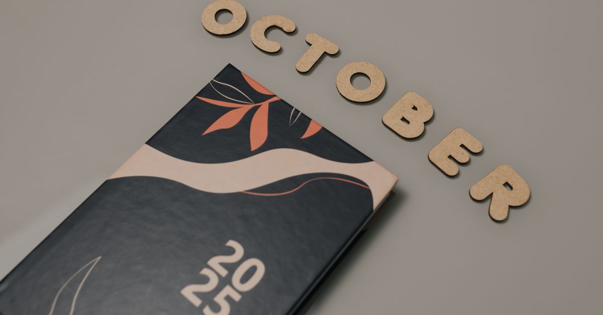 Stylish October 2025 planner with creative leaf art on a neutral background, perfect for organization.