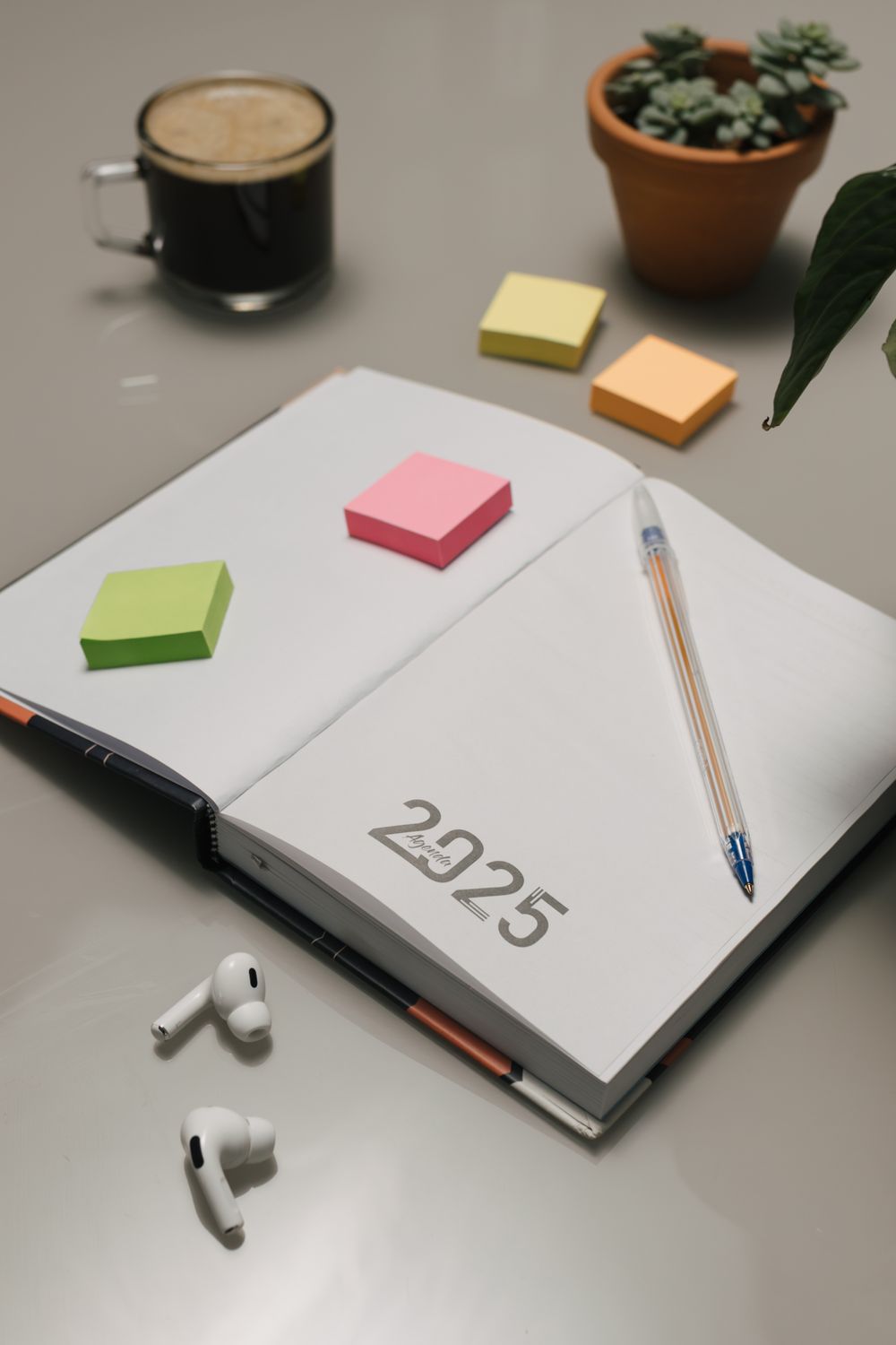 Open notebook with 2025 date and office supplies · Free Stock Photo