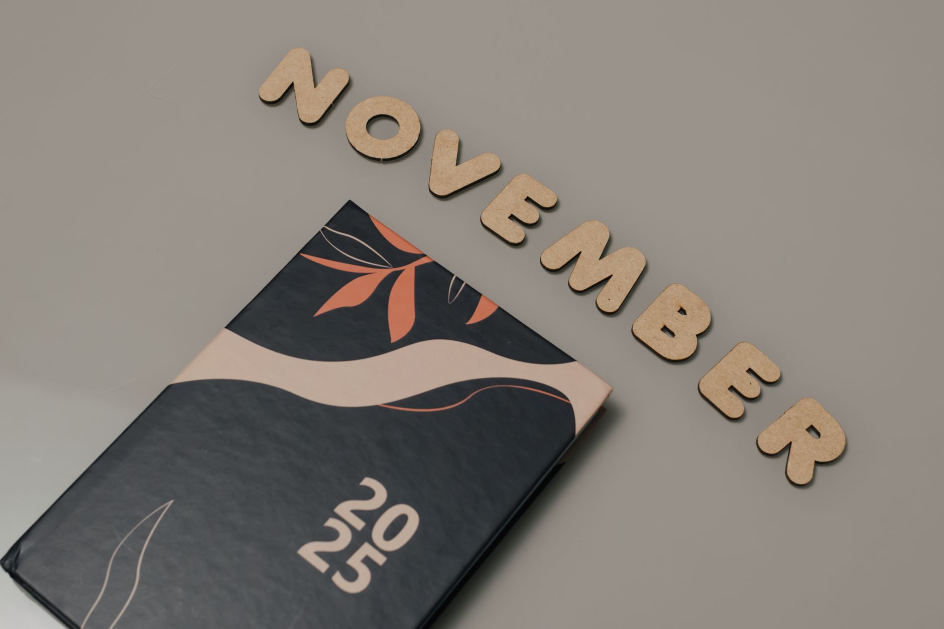 Aesthetic 2025 planner with November wooden letters and modern abstract design, perfect for planning.