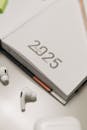 Modern Planner on Desk with Earbuds