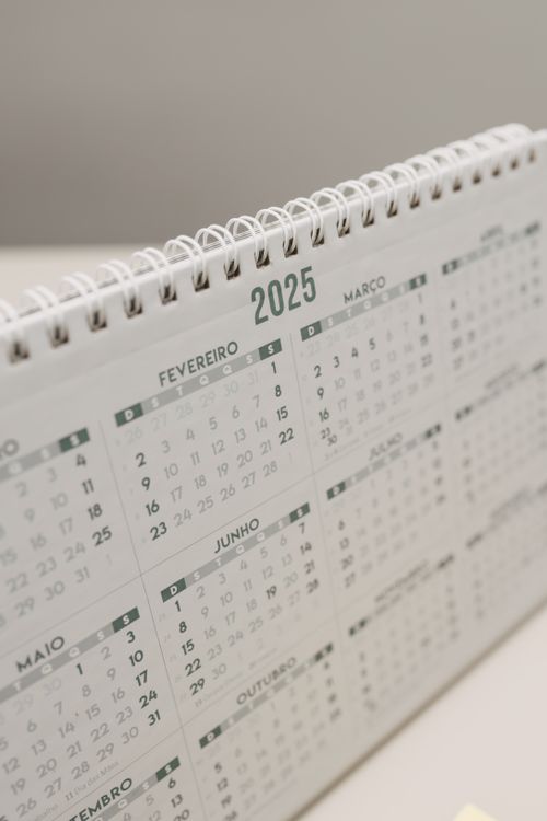 Free A sleek 2025 desk calendar with a spiral binding, showcasing monthly views. Stock Photo