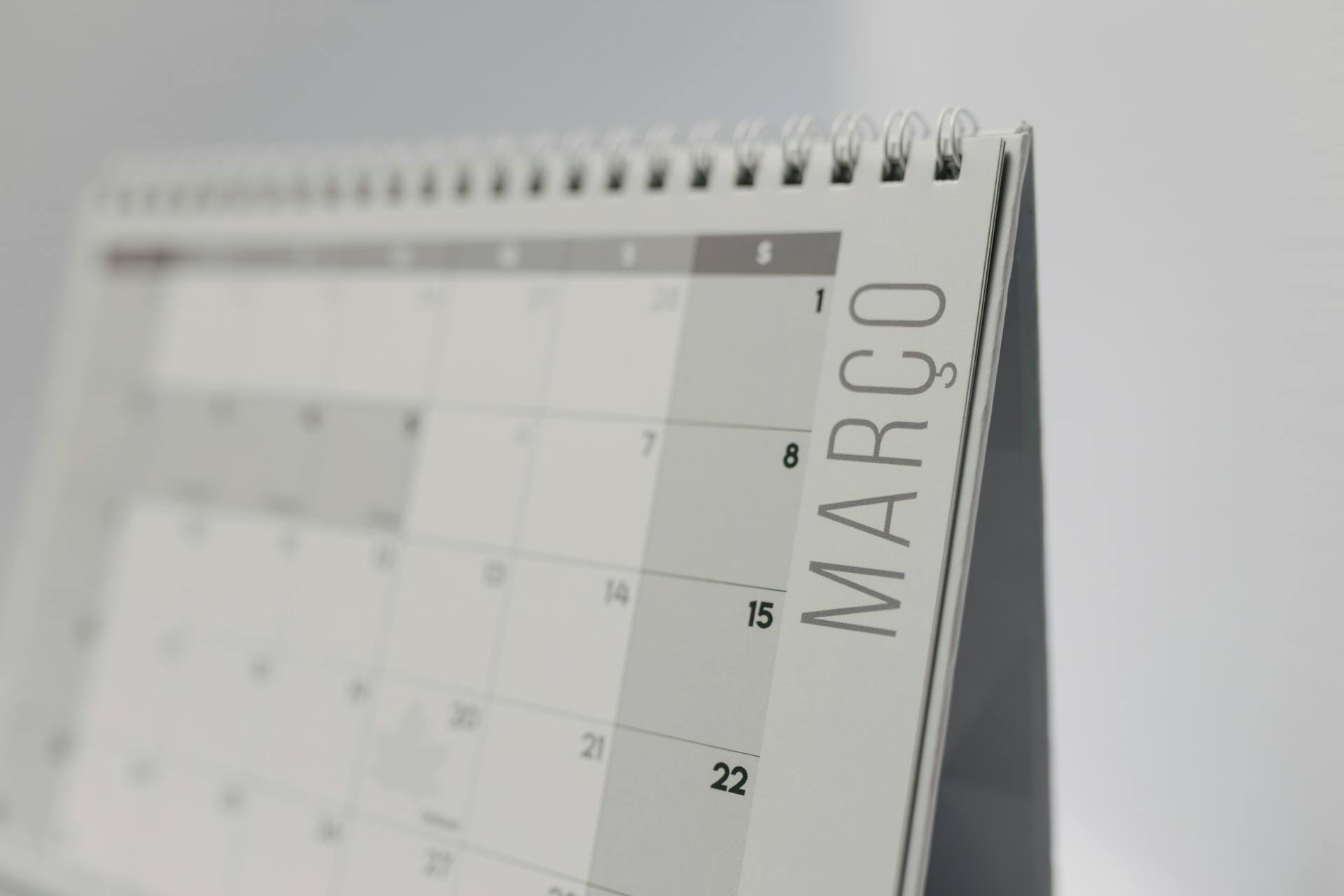 Close-up of a spiral-bound desk calendar showing March in a minimalist style.