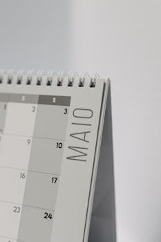 A close-up of a spiral-bound desk calendar emphasizing the month of May.